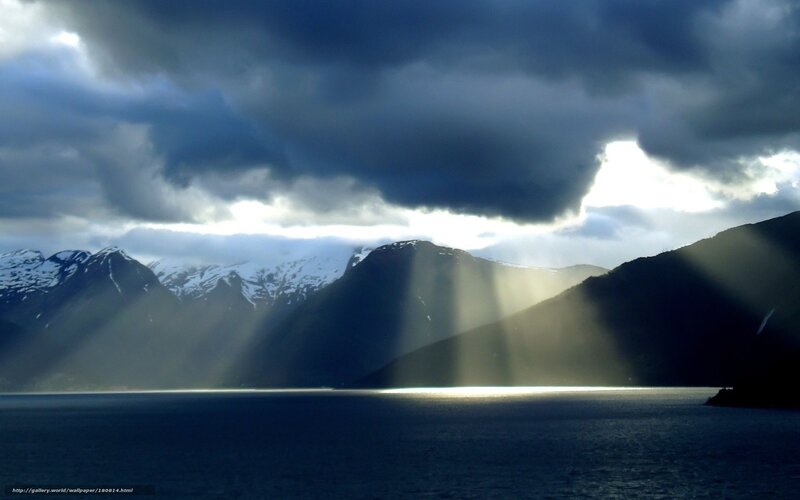 Sunlight Through Clouds over Fjord