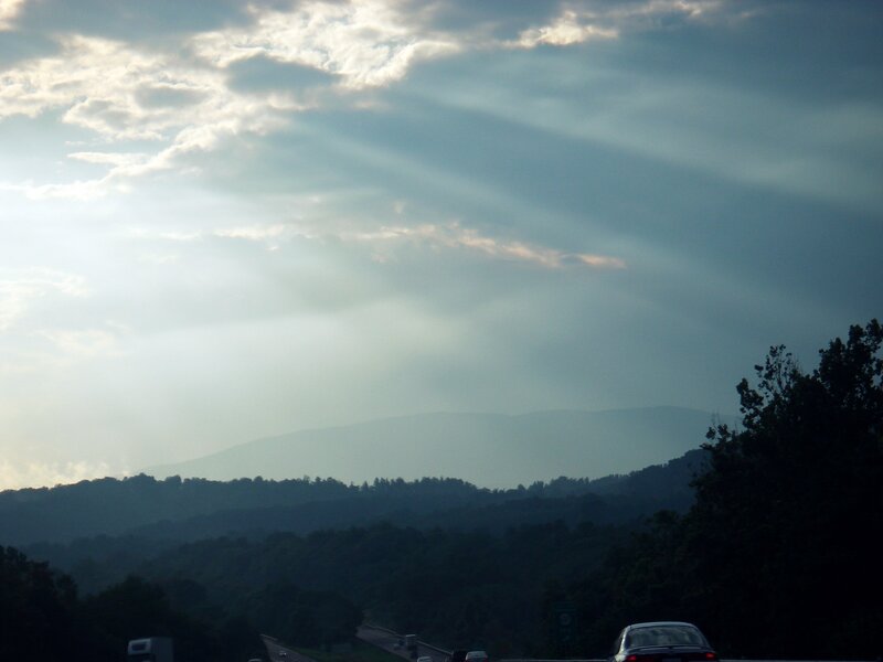 Sunlight through clouds over mountains