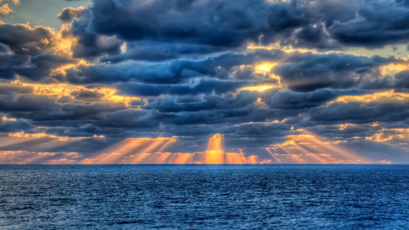Sunlight Through Clouds over Ocean — Blue, Dramatic, Sunset, Photograph