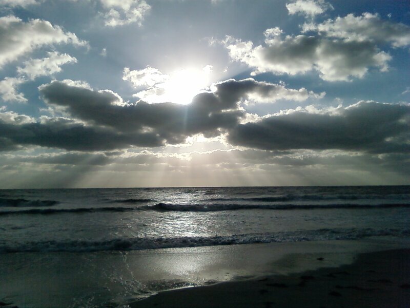 Sunlight Through Clouds over Ocean — Blue, Dramatic