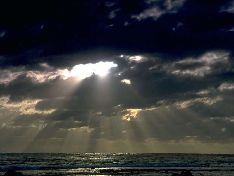 Sunlight Through Clouds over Ocean — Dark Blue