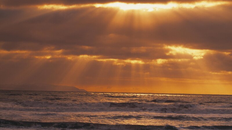 Sunlight Through Clouds over Ocean — Orange, Dramatic, Sunset, Photograph, Mountain