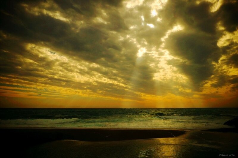 Sunlight Through Clouds over Ocean — Yellow, Dramatic