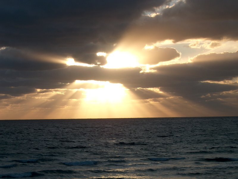 Sunlight Through Clouds over Ocean — Yellow