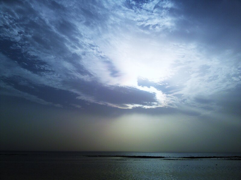 Sunlight Through Clouds over Sea — Blue