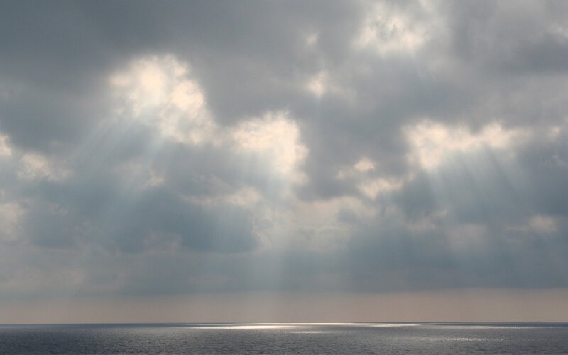 Sunlight Through Clouds over Sea — Gray, Dramatic, Photograph