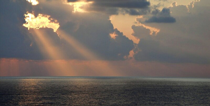 Sunlight Through Clouds over Sea — Gray, Dramatic, Sunset