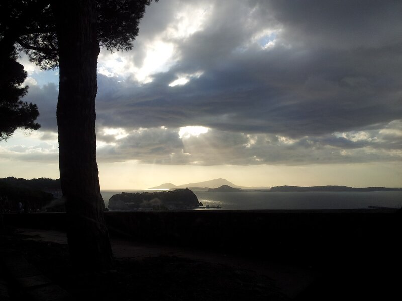 Sunlight through clouds over sea