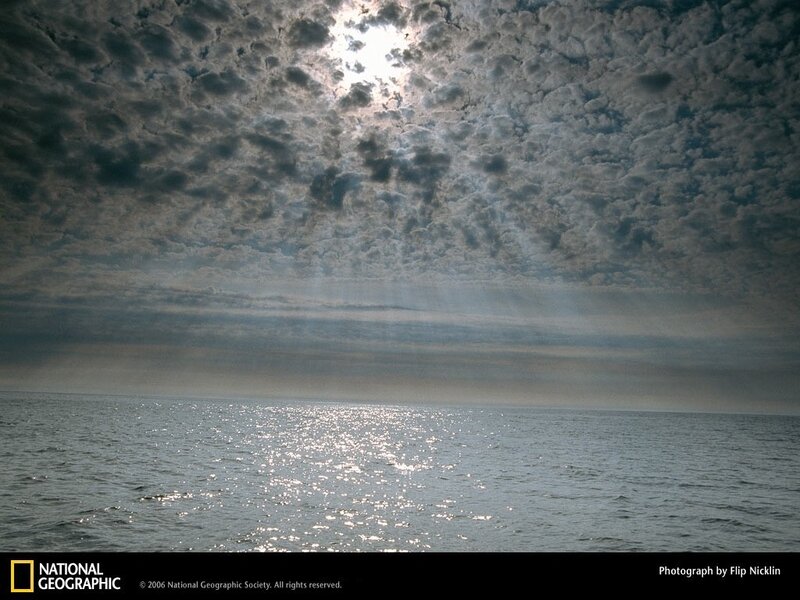 Sunlight through clouds over water