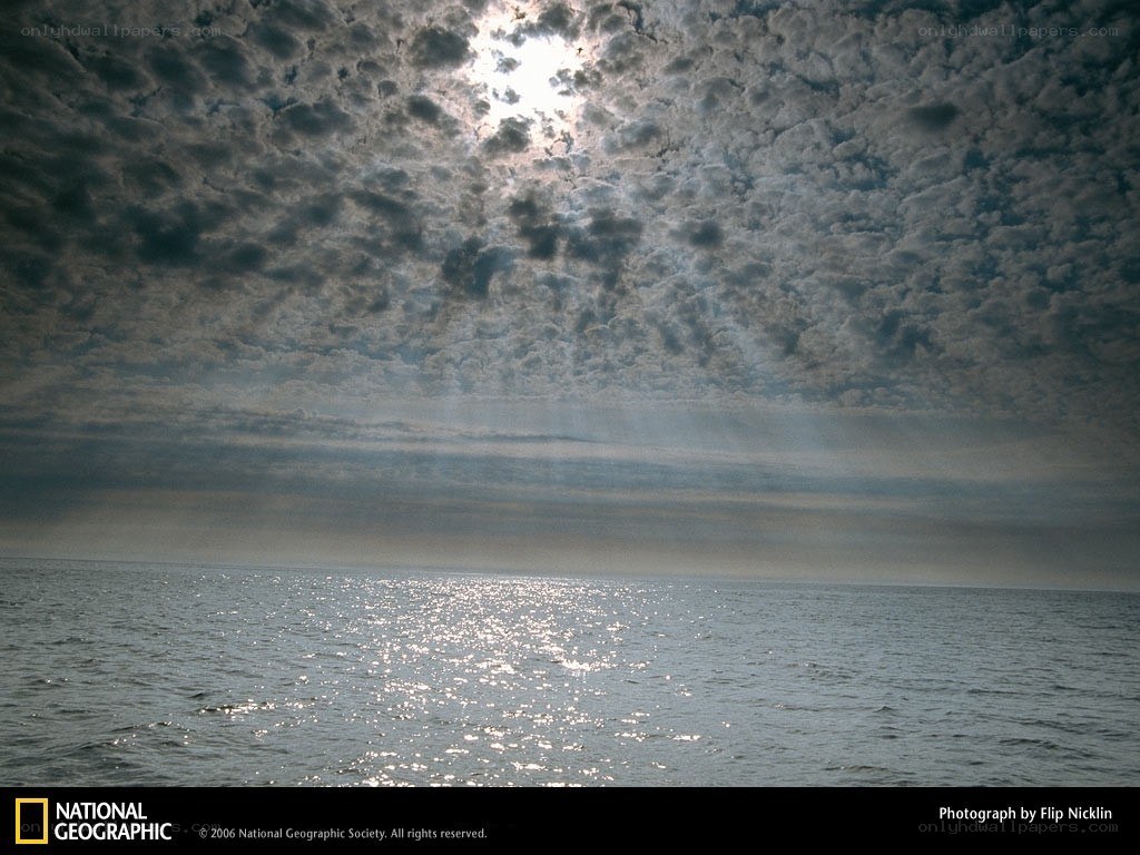 Sunlight through clouds over water