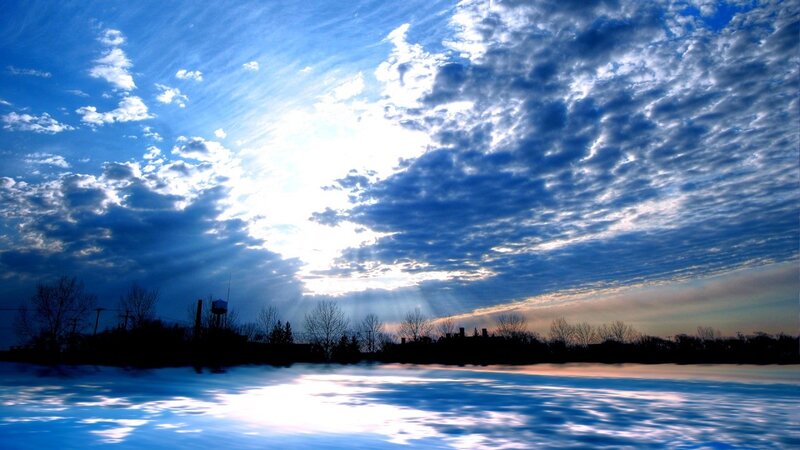 Sunlight through clouds over water