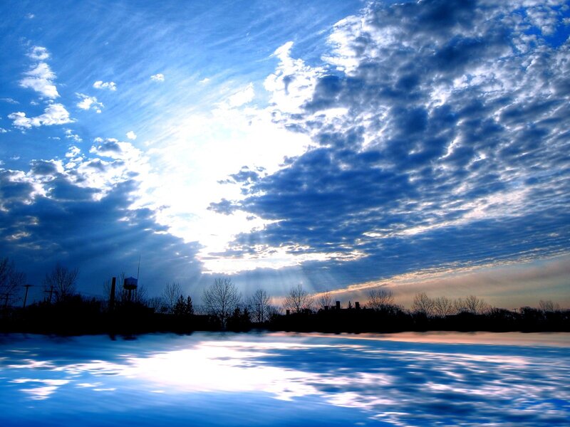 Sunlight through clouds over water