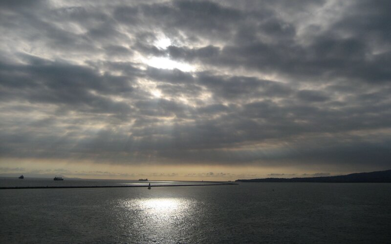 Sunlight Through Clouds over Water — Gray, Dramatic