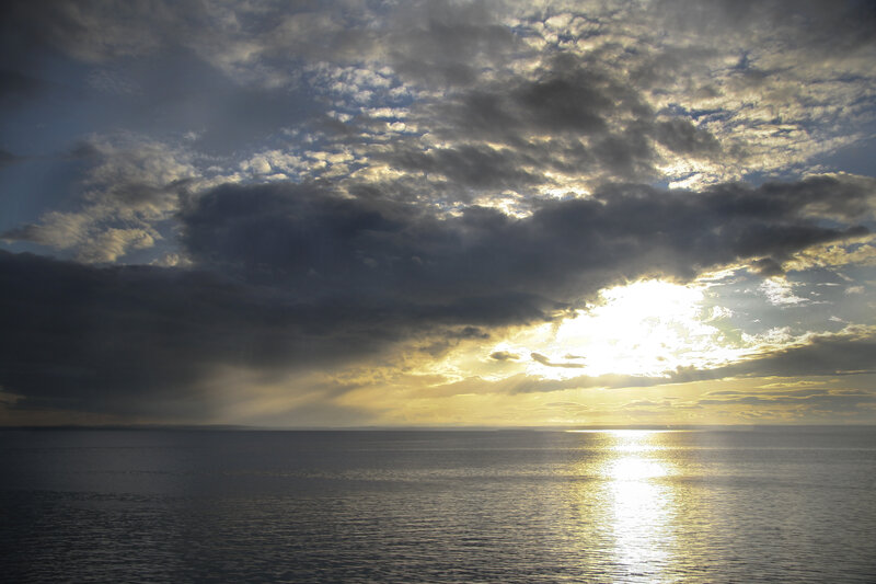 Sunlight Through Clouds over Water — Yellow