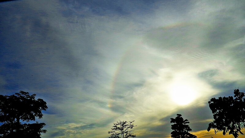 Sunlight through clouds with rainbow
