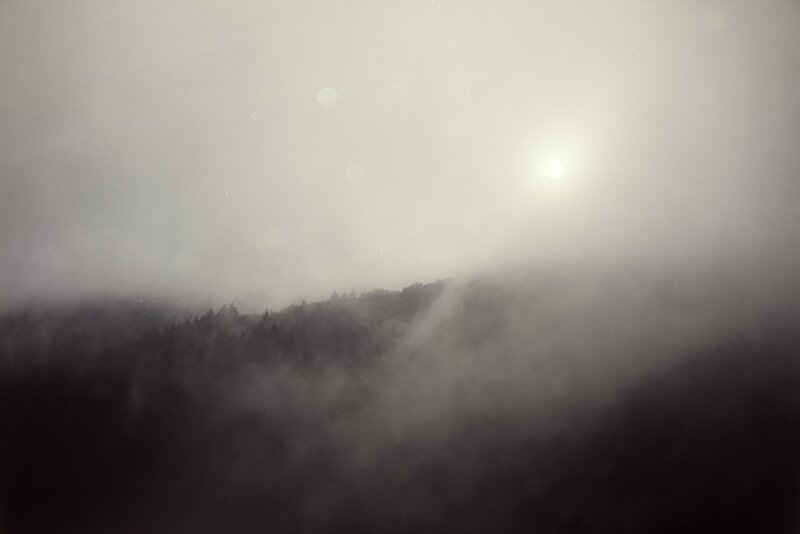 Sunlight through mountain fog
