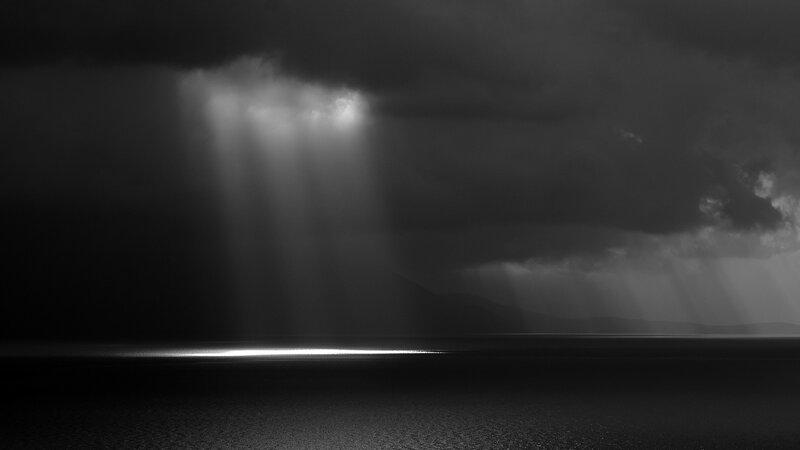 Sunlight Through Storm Clouds — Black, Dramatic, Photograph