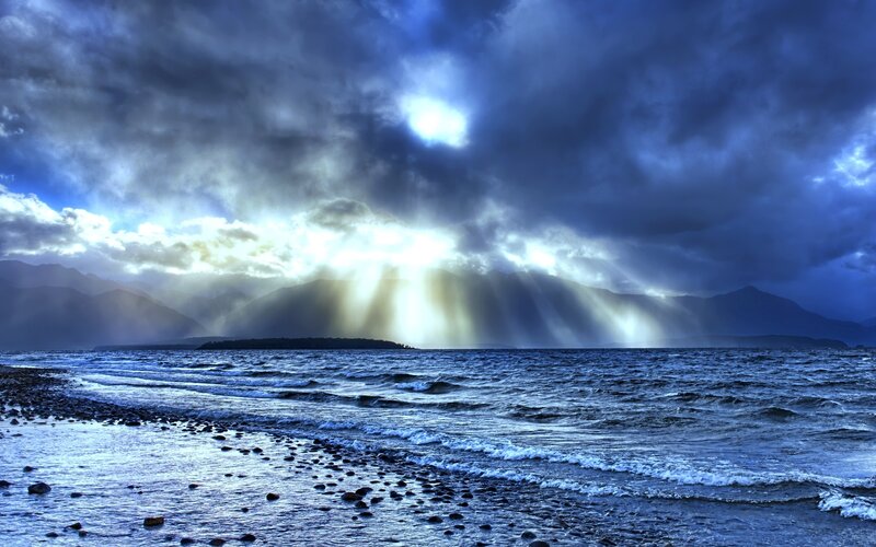 Sunlight Through Storm Clouds — Blue, Dramatic, Sunrise, Photograph, Mountains