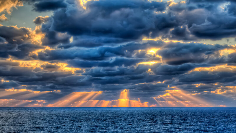 Sunlight Through Storm Clouds — Blue, Dramatic, Sunset, Photograph, Ocean