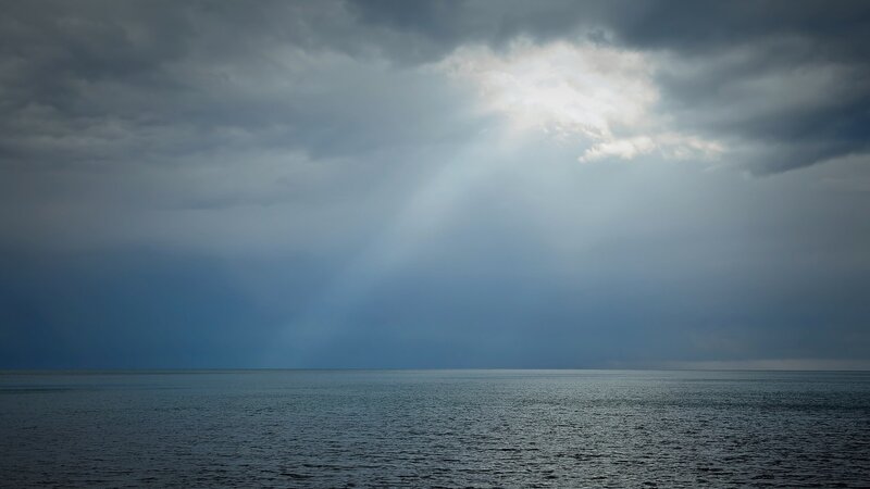 Sunlight Through Storm Clouds — Gray, Dramatic, Photograph, Sea