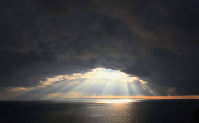 Sunlight Through Storm Clouds — Gray, Dramatic, Sunset, Photograph, Ocean