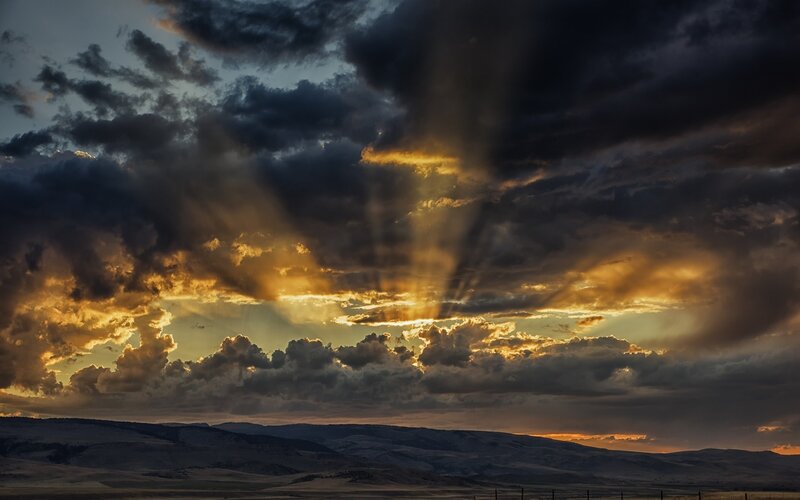 Sunlight Through Storm Clouds — Orange, Dramatic