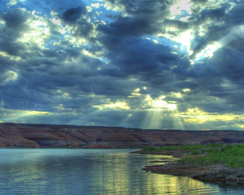 Sunlight through storm clouds over lake