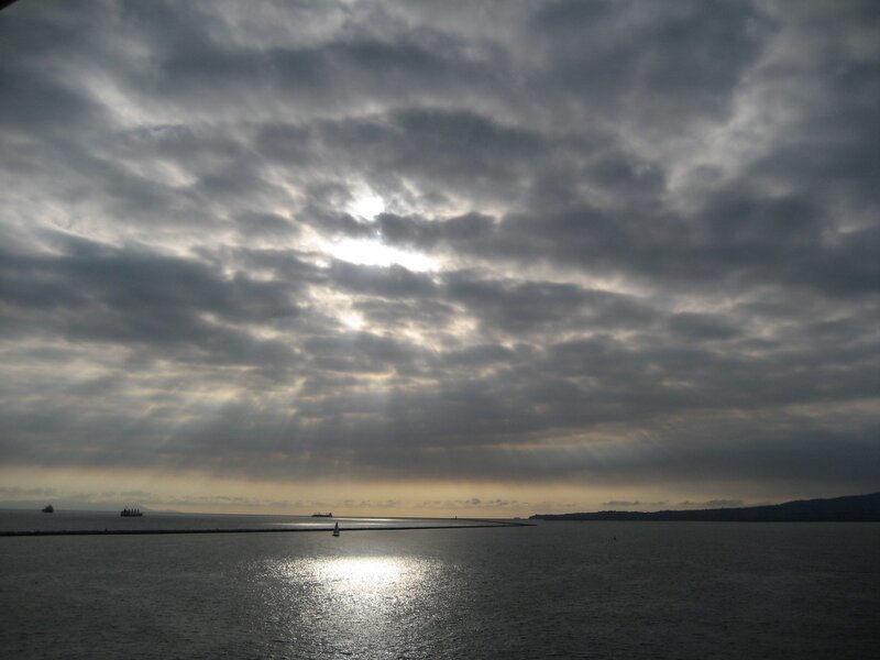 Sunlight through storm clouds over water
