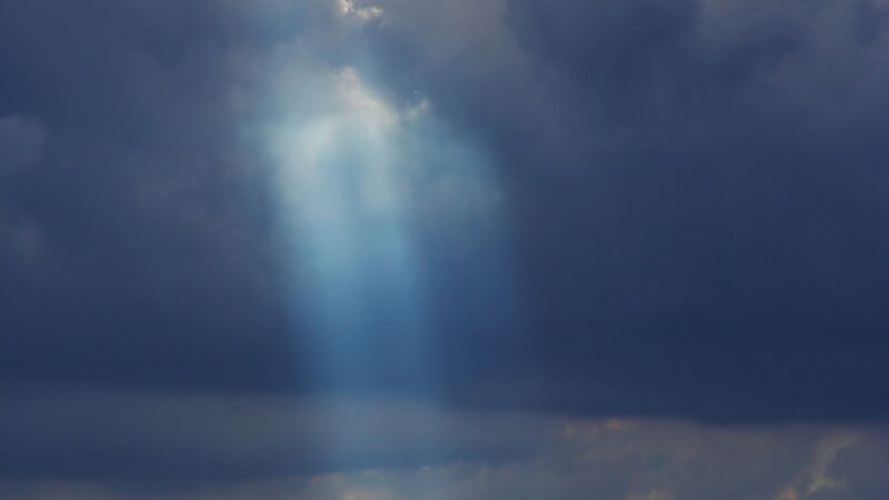 Sunlight Through Storm Clouds — Photograph