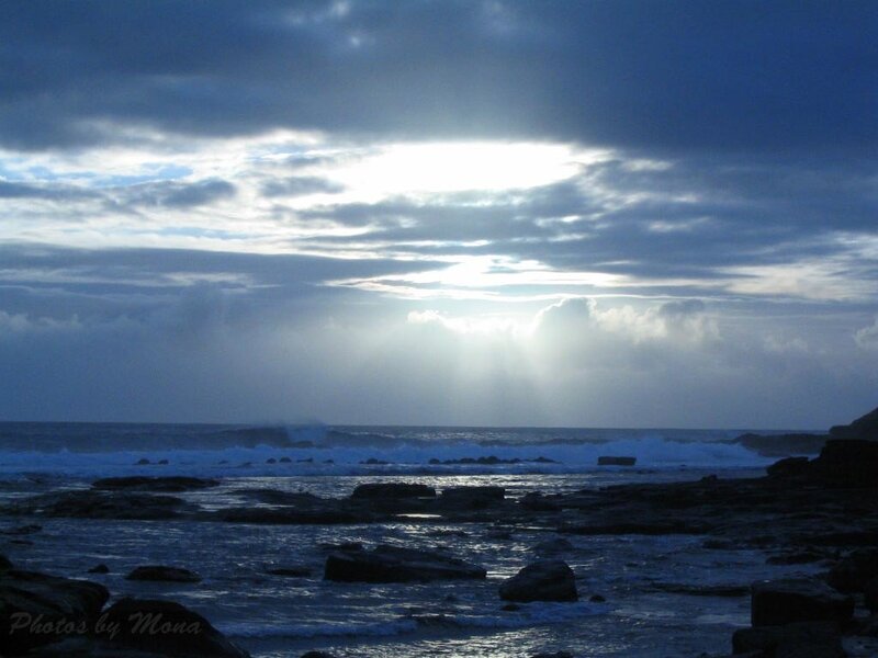 Sunlight through stormy clouds at sea