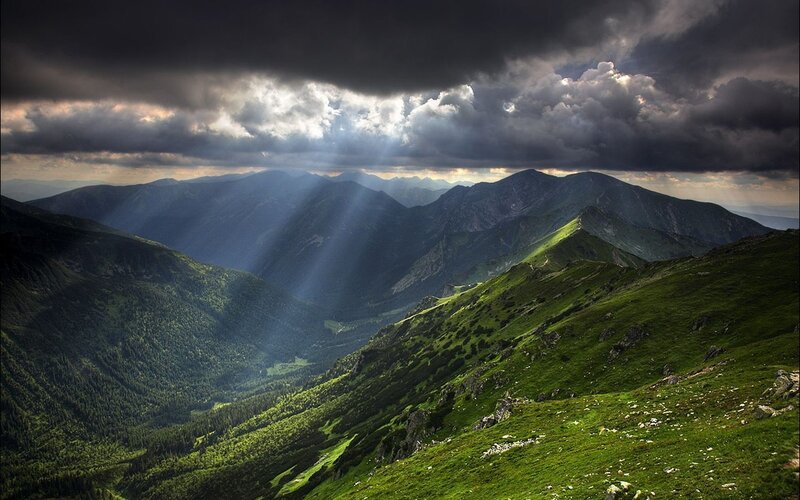 Sunlight through stormy mountains