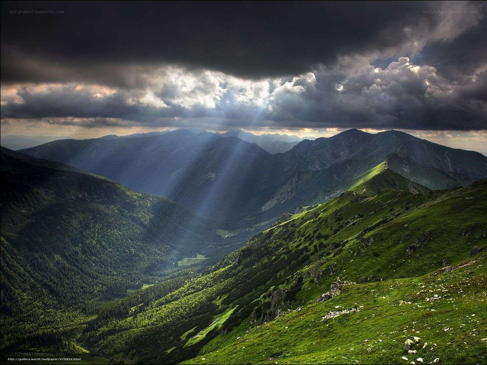 Sunlight through stormy mountains