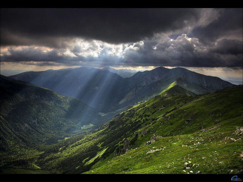 Sunlight through stormy mountains