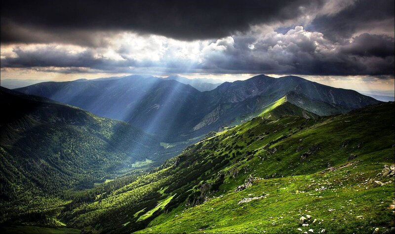 Sunlight through stormy mountains