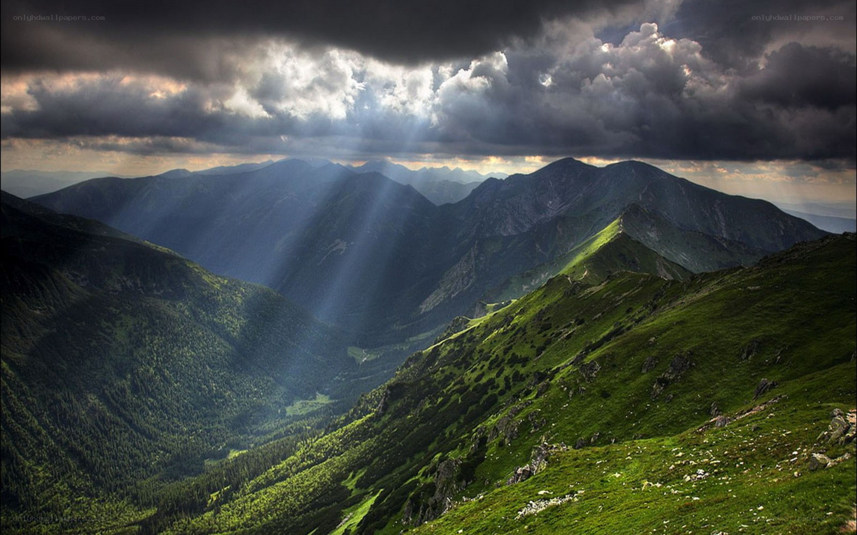 Sunlight through stormy mountains