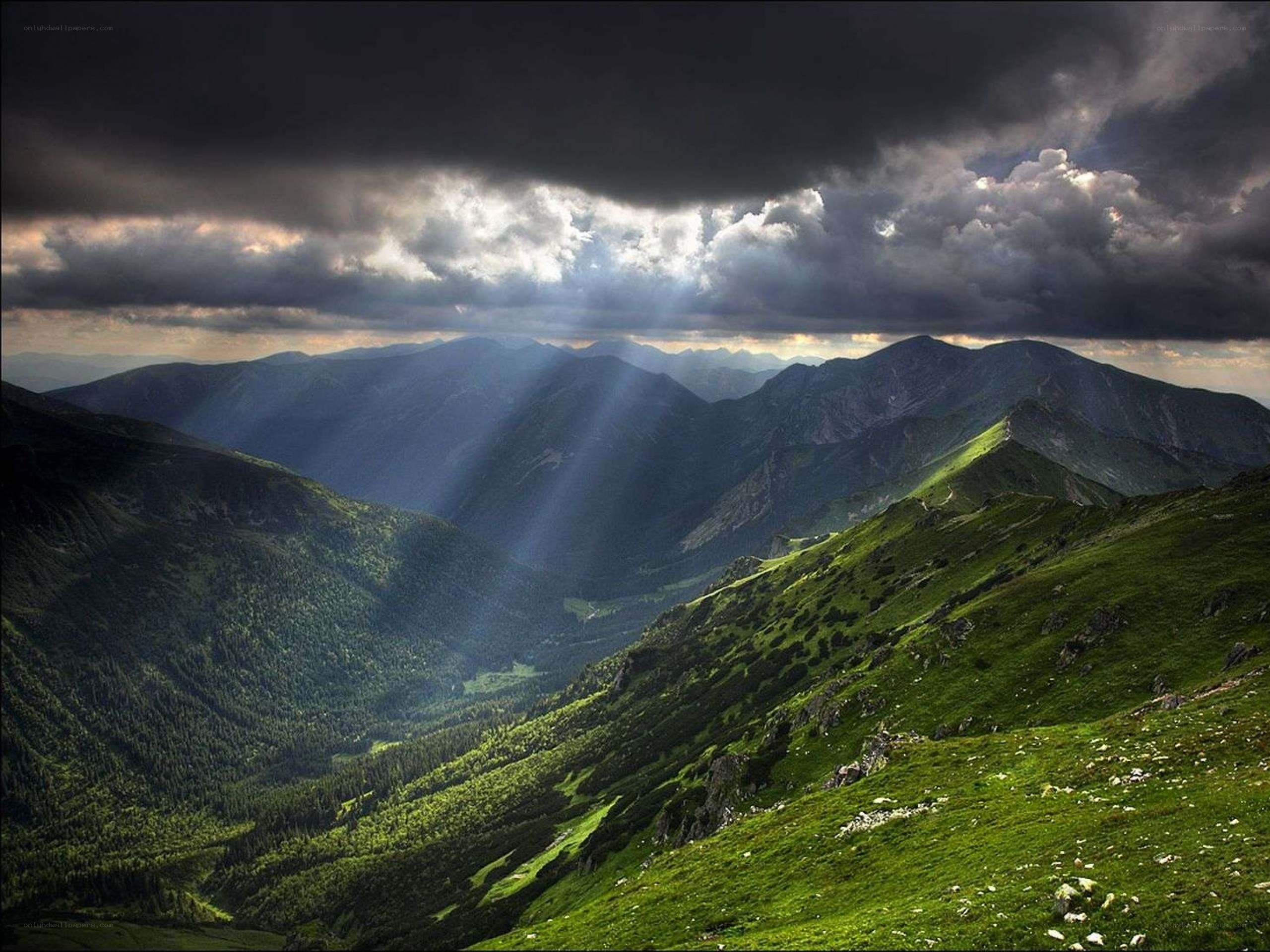 Sunlight through stormy mountains