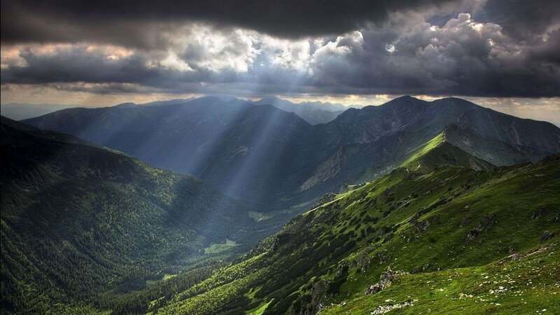 Sunlight through stormy mountains