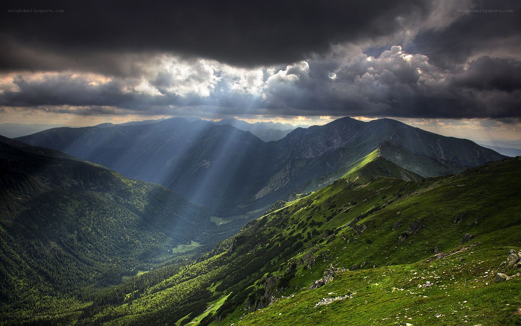Sunlight through stormy mountains