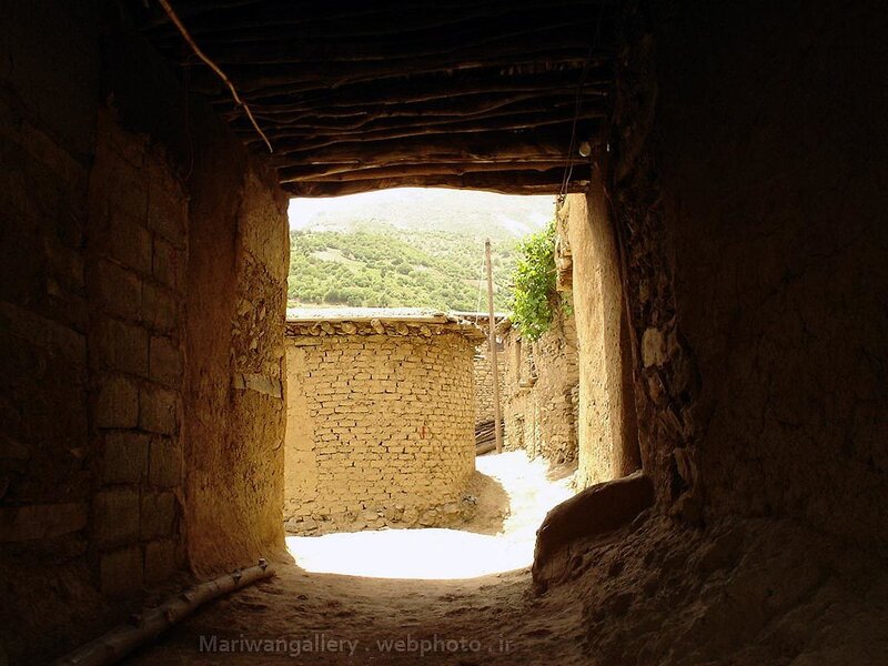 Sunlit alley in a mud-brick village