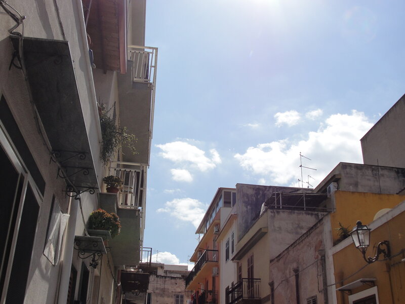 Sunlit alley with balconies