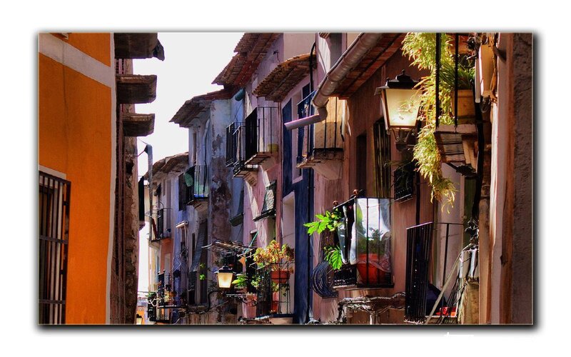 Sunlit alley with colorful buildings