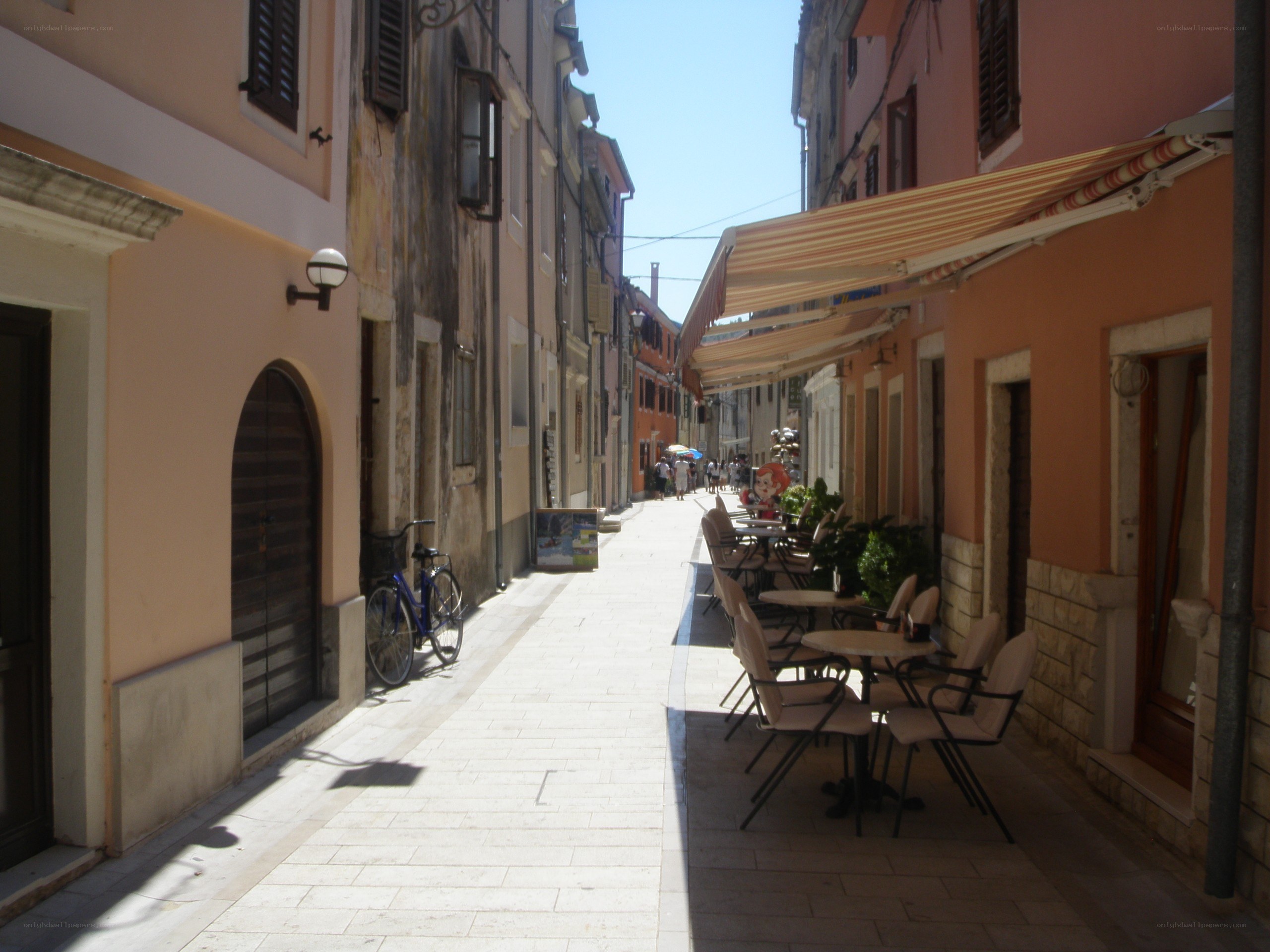 Sunlit alley with outdoor seating
