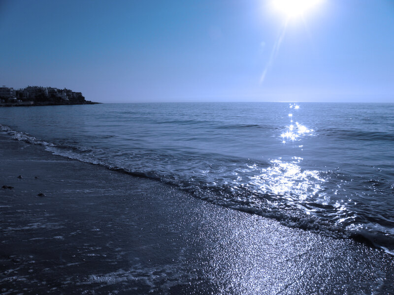 Sunlit beach with gentle waves