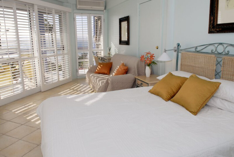 Sunlit bedroom with ocean view