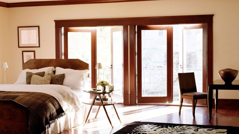 Sunlit bedroom with wooden doors