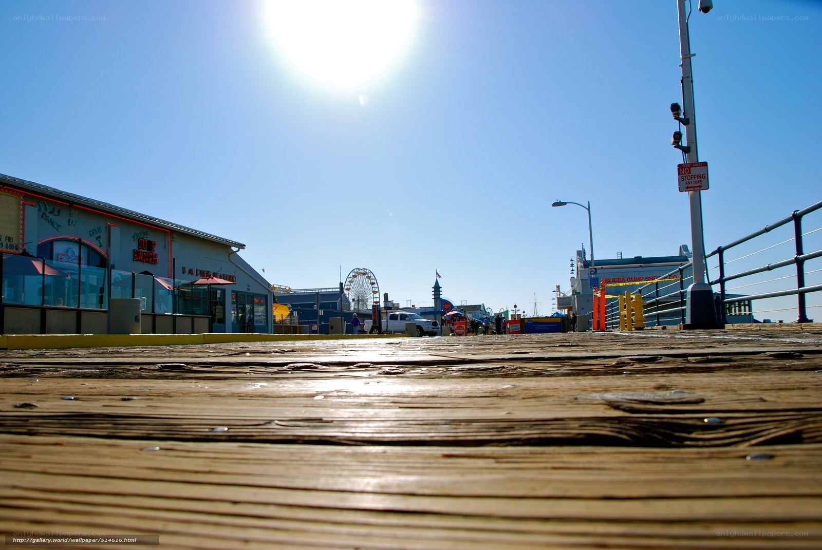 Sunlit boardwalk with Ferris wheel