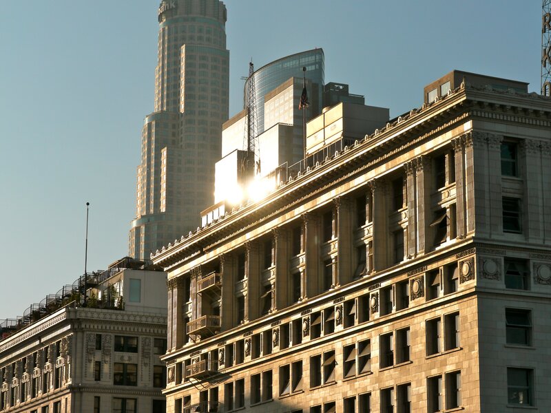 Sunlit city buildings at dawn