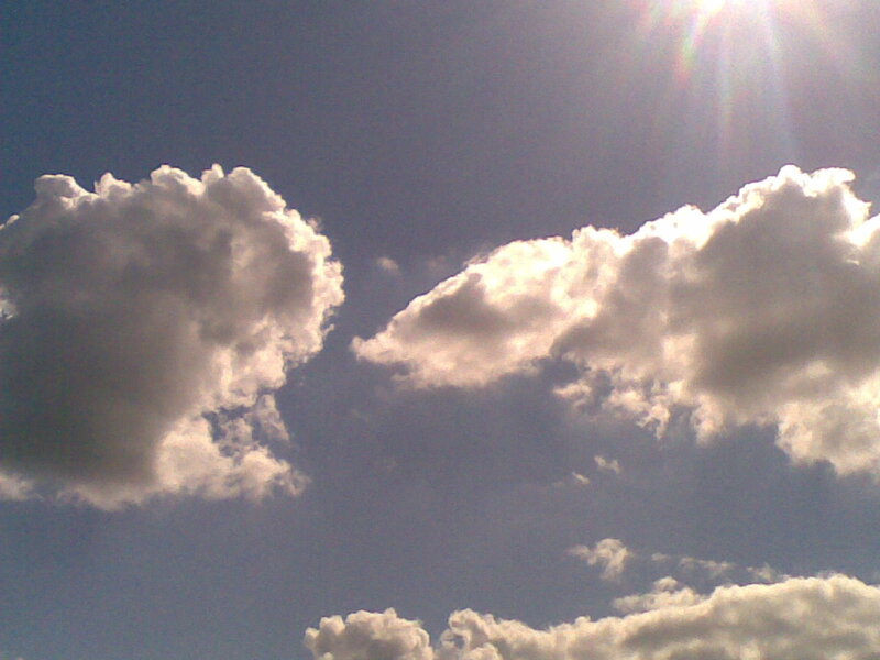 Sunlit clouds in blue sky