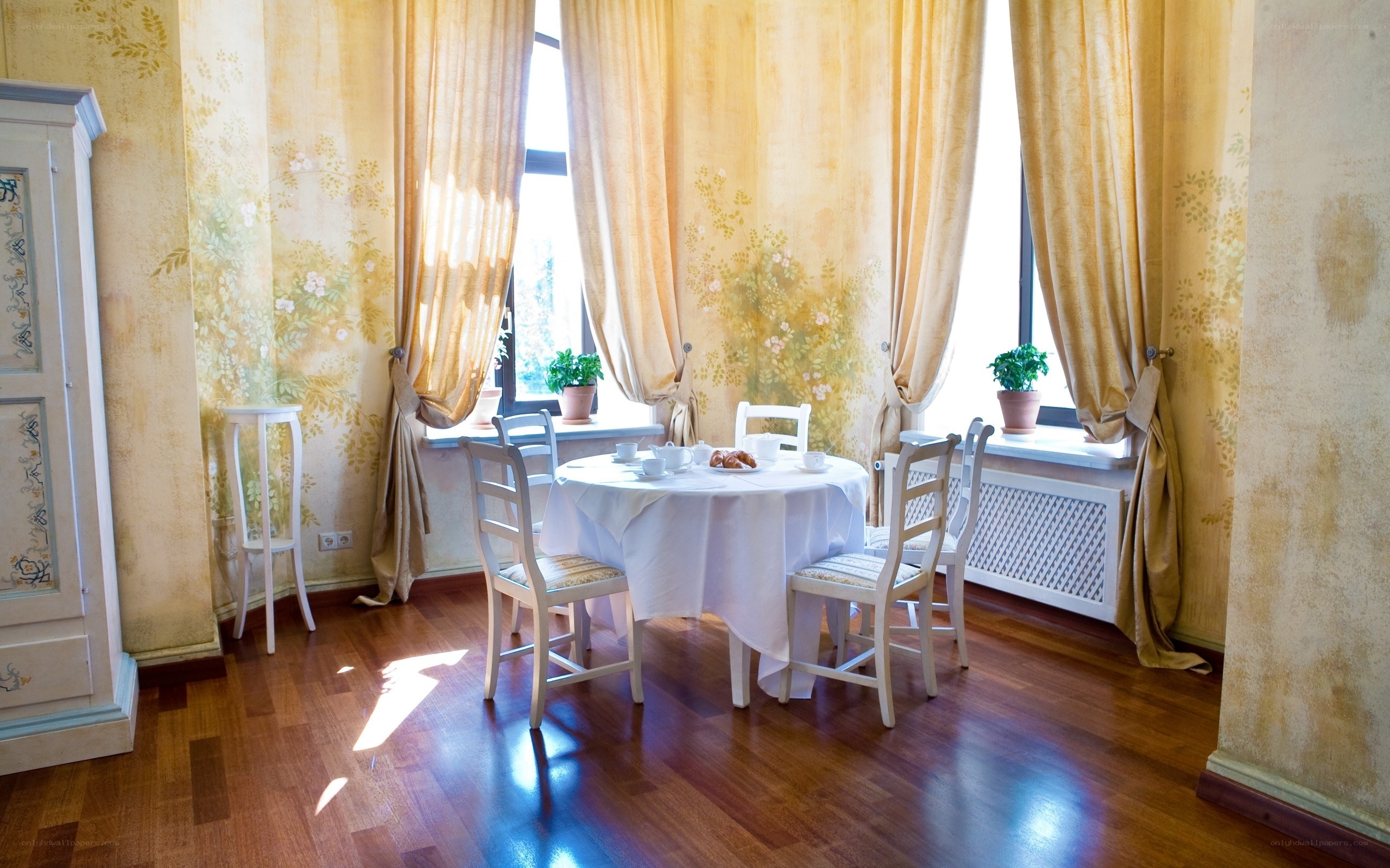 Sunlit dining room with floral wallpaper