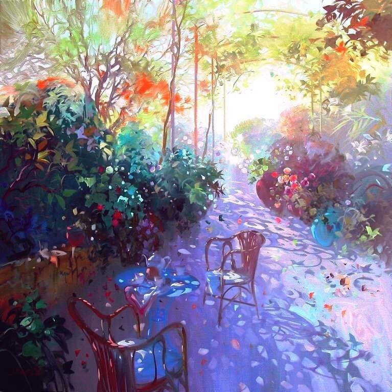 Sunlit garden path with chairs